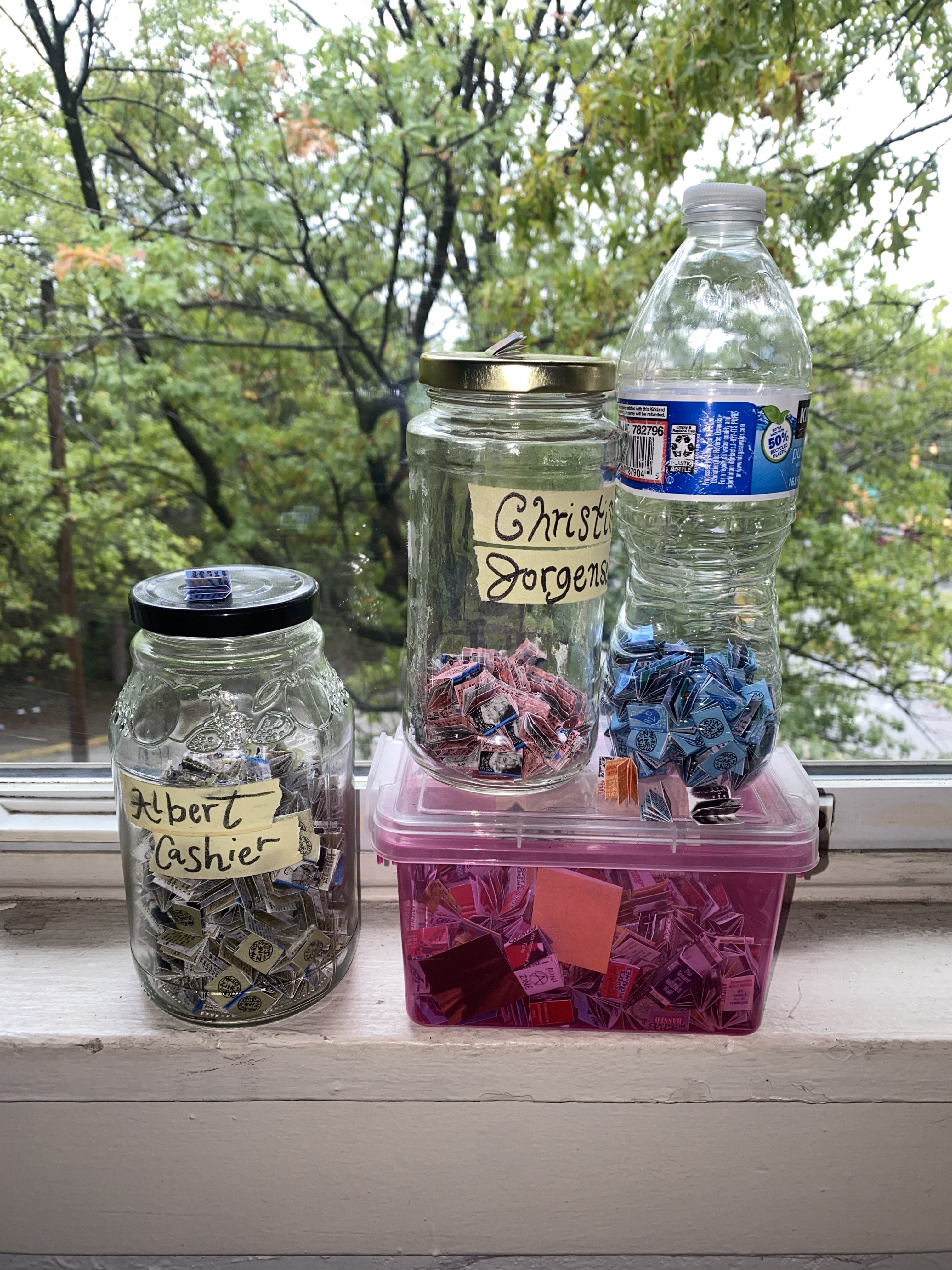 tiny zines (smaller than a dime each) are jarred and bottled in a windowsill