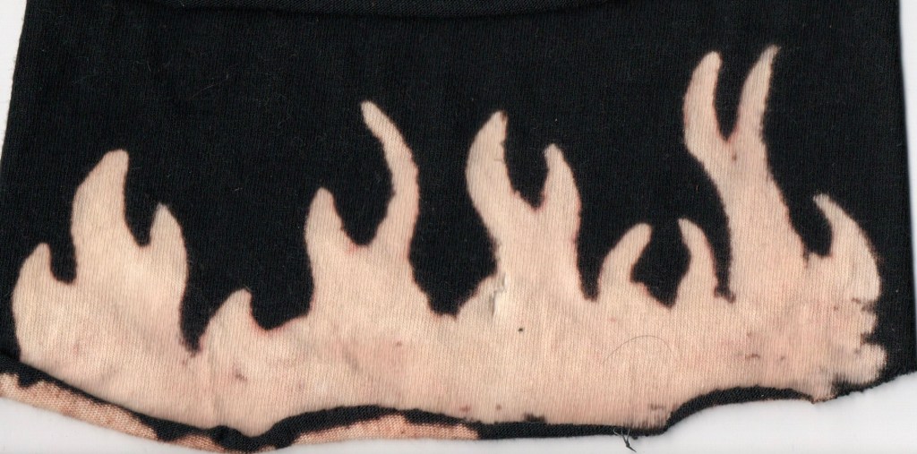 a scanned image of fire bleached onto a scrap of knitwear